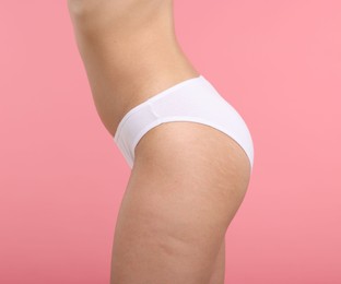 Photo of Woman with perfect slim body on pink background, closeup