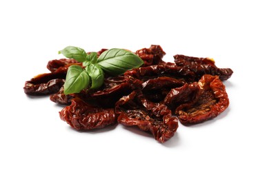 Photo of Delicious sun dried tomatoes and basil isolated on white