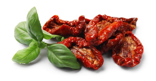 Photo of Delicious sun dried tomatoes and basil isolated on white