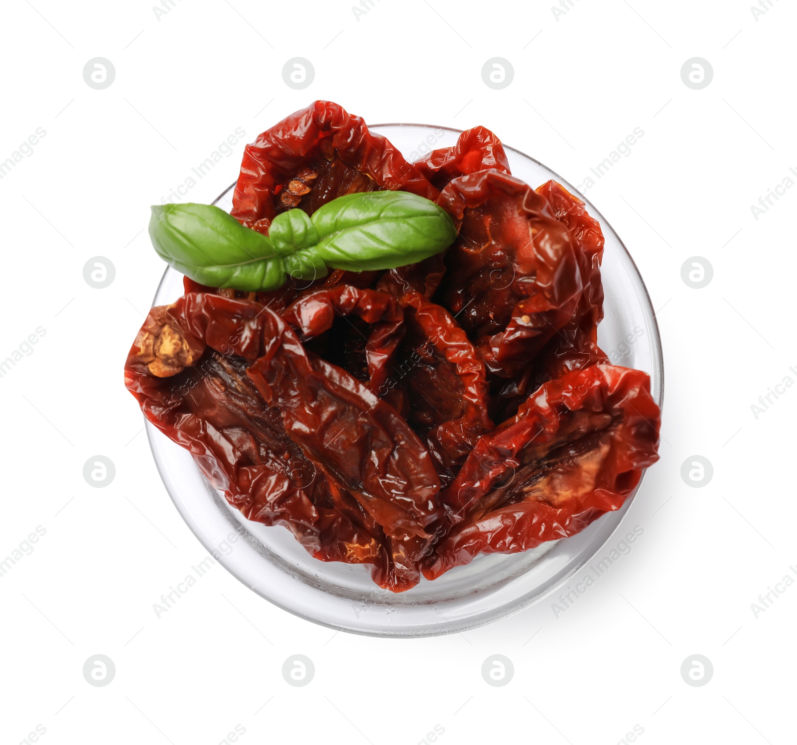 Delicious sun dried tomatoes with basil in glass bowl isolated on white, top view Photo of Delicious sun dried tomatoes with basil in glass bowl isolated on white, top view