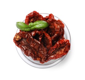 Photo of Delicious sun dried tomatoes with basil in glass bowl isolated on white, top view