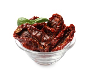 Photo of Delicious sun dried tomatoes with basil in glass bowl isolated on white