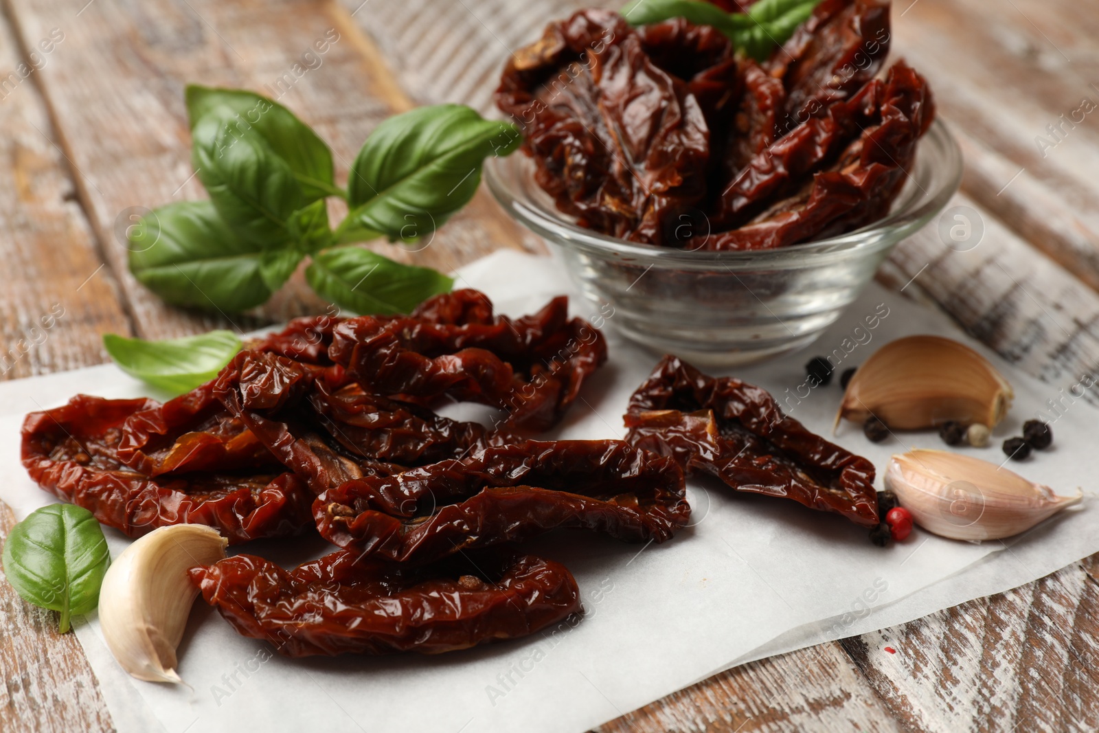 Delicious sun dried tomatoes and spices on wooden table, closeup Photo of Delicious sun dried tomatoes and spices on wooden table, closeup