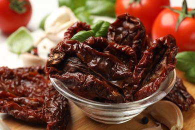 Photo of Delicious sun dried tomatoes, fresh vegetables and spices on table, closeup