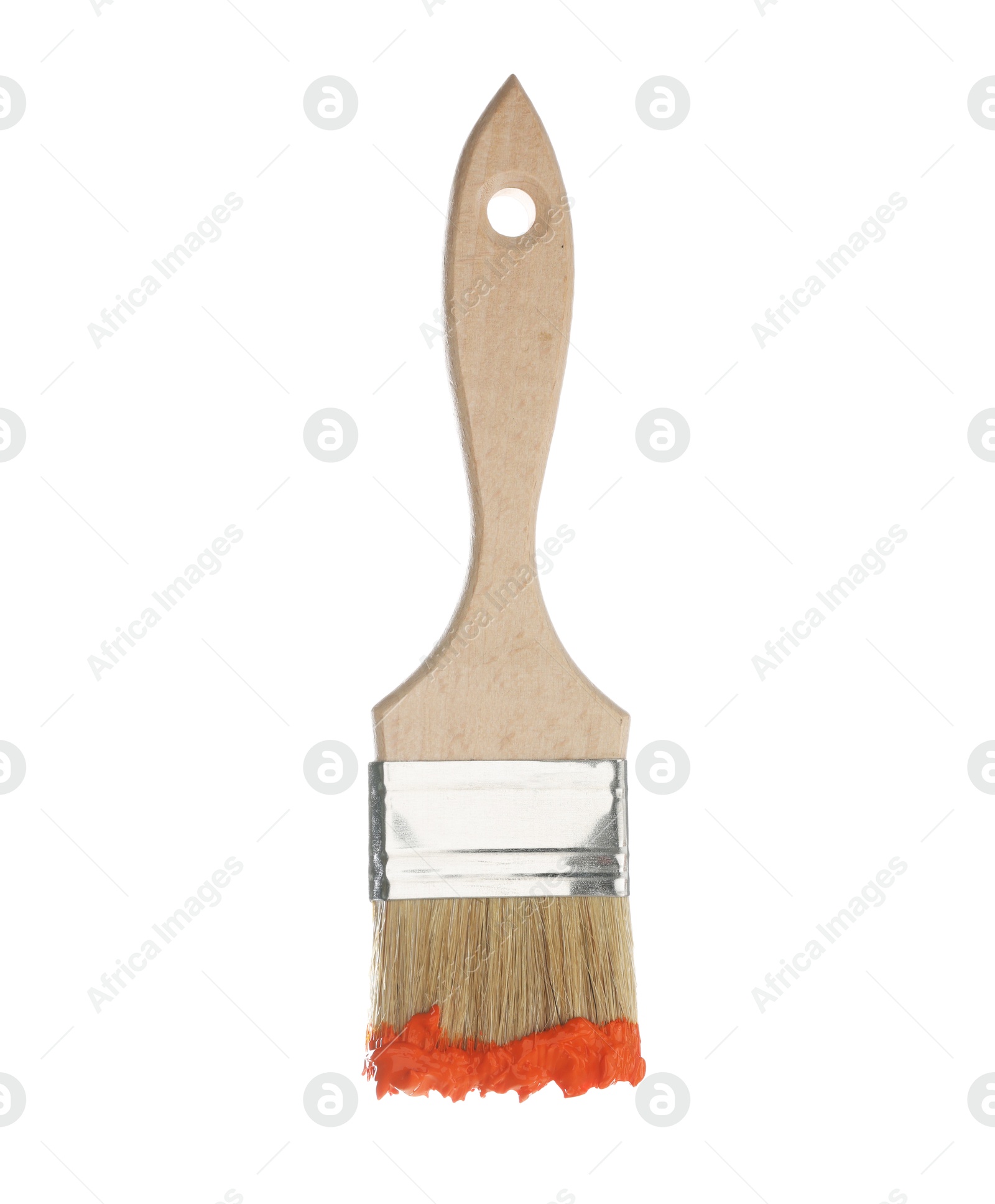 Brush with orange paint isolated on white Photo of Brush with orange paint isolated on white
