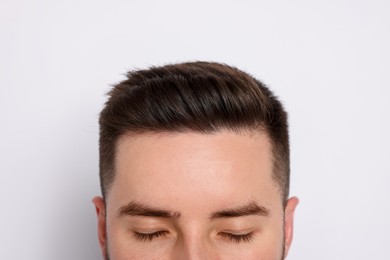 Photo of Man after hair loss treatment on light background, closeup