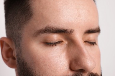 Photo of Man before eyebrows correction on light background, closeup
