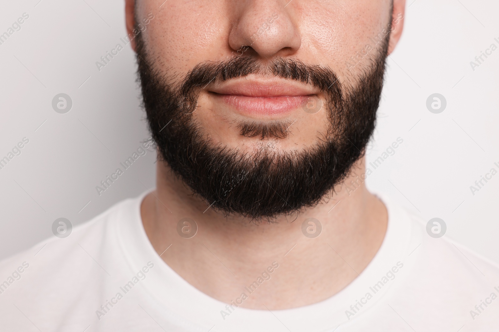 Man before shaving on light background, closeup Photo of Man before shaving on light background, closeup