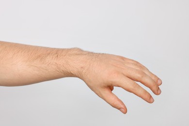 Photo of Man on light grey background, closeup view