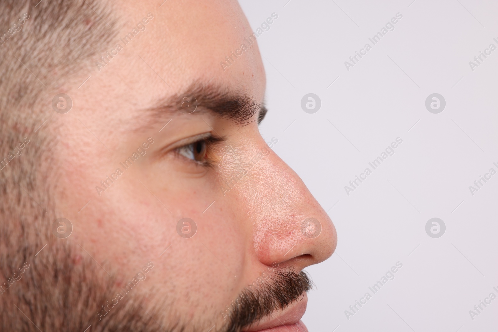 Man on light background, closeup. Space for text Photo of Man on light background, closeup. Space for text