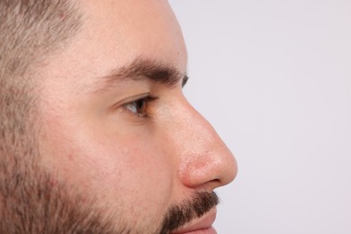Photo of Man on light background, closeup. Space for text