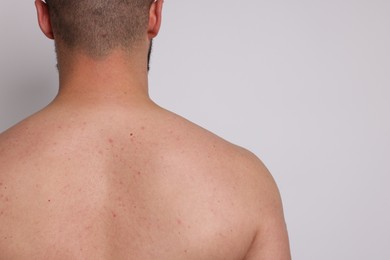 Photo of Man posing on light background, back view