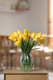 Photo of Beautiful tulips in vase on wooden table indoors. Space for text