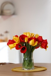 Photo of Beautiful tulips in vase on wooden table indoors. Space for text