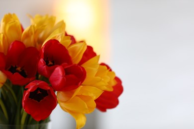 Photo of Bouquet of beautiful tulips on blurred background, closeup. Space for text