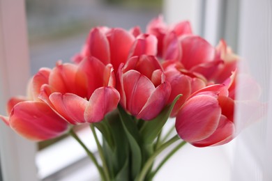 Photo of Bouquet of beautiful tulips near window indoors, closeup
