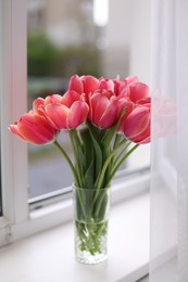 Photo of Bouquet of beautiful tulips on window sill
