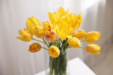 Photo of Bouquet of beautiful tulips on table indoors, closeup