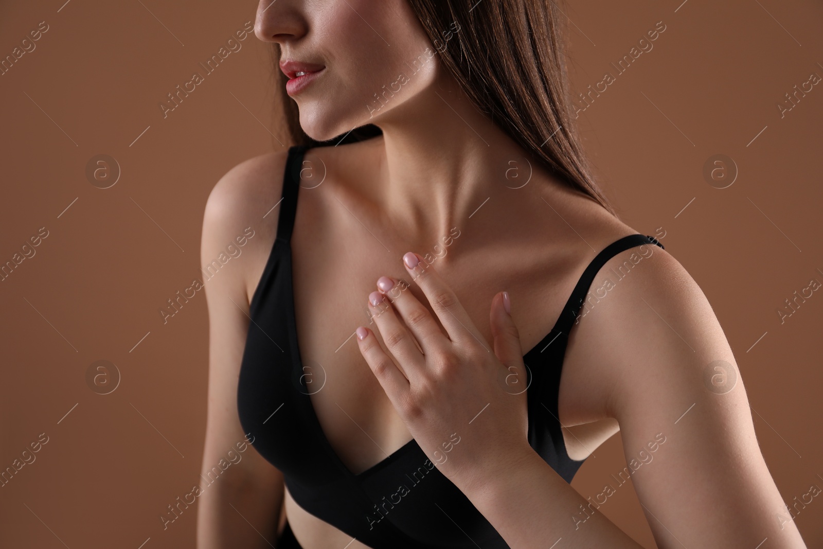 Woman with beautiful collarbone on brown background, closeup Photo of Woman with beautiful collarbone on brown background, closeup