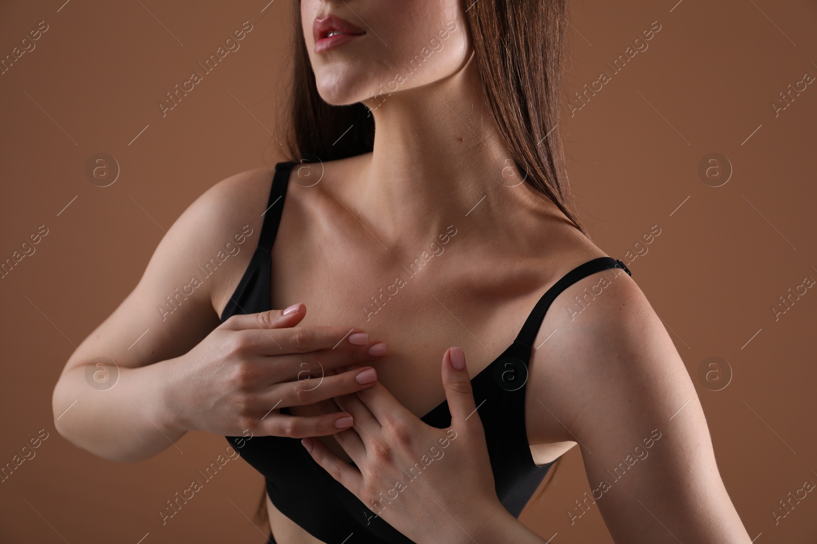 Woman with beautiful collarbone on brown background, closeup Photo of Woman with beautiful collarbone on brown background, closeup