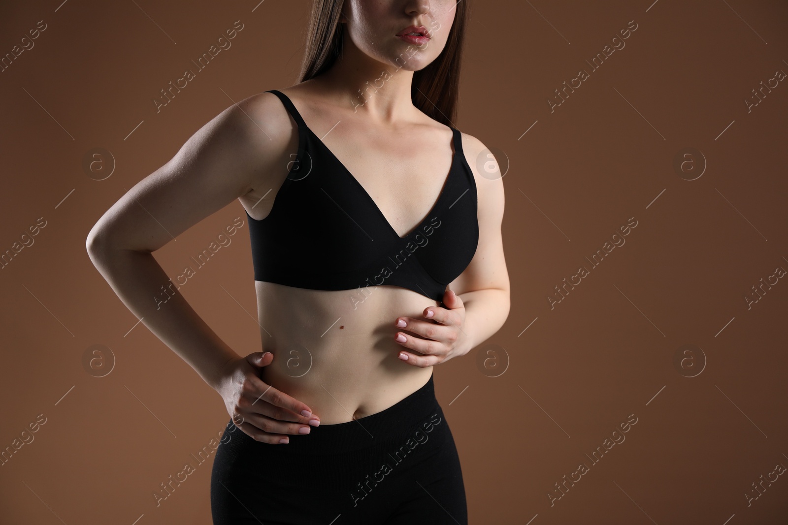 Woman with beautiful body on brown background, closeup Photo of Woman with beautiful body on brown background, closeup