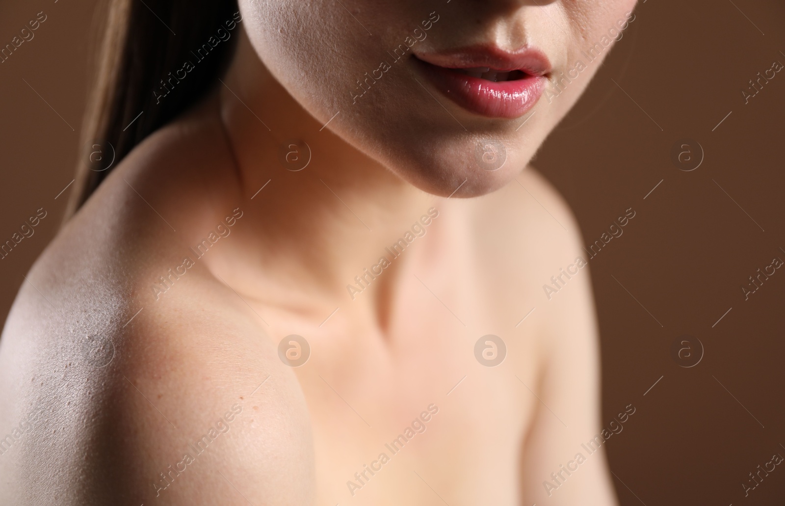 Woman with beautiful collarbones on brown background, closeup Photo of Woman with beautiful collarbones on brown background, closeup