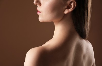 Photo of Beautiful woman on brown background, back view