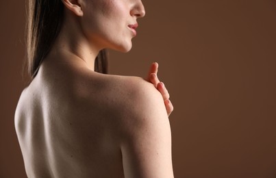 Photo of Beautiful woman on brown background, back view. Space for text