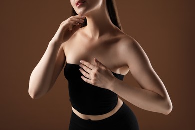 Photo of Woman with beautiful collarbones on brown background, closeup