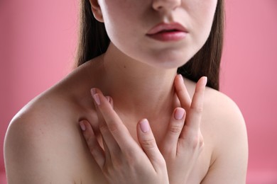 Photo of Woman with beautiful collarbones and neck on pink background, closeup