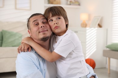 Photo of Portrait of father and his son at home