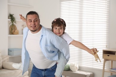 Photo of Father and his son spending time together at home