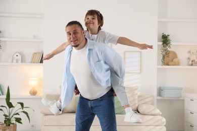Photo of Father and his son spending time together at home