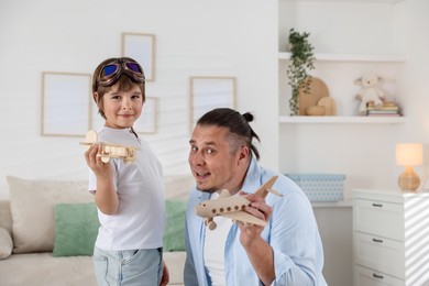 Photo of Father and his son spending time together at home