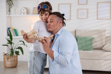 Photo of Father and his son spending time together at home