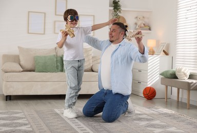 Photo of Father and his son spending time together at home