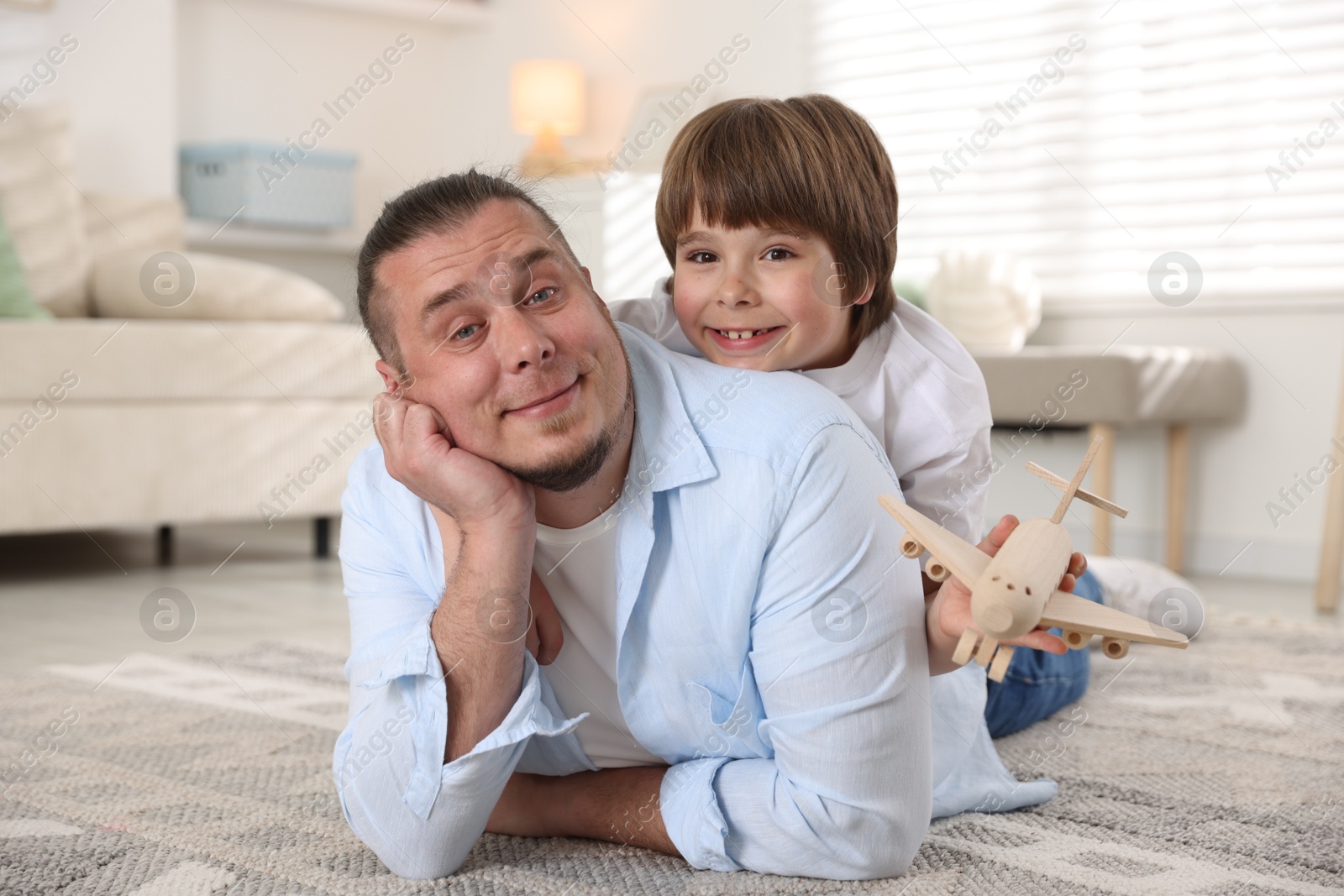 Father and his son on floor at home Photo of Father and his son on floor at home