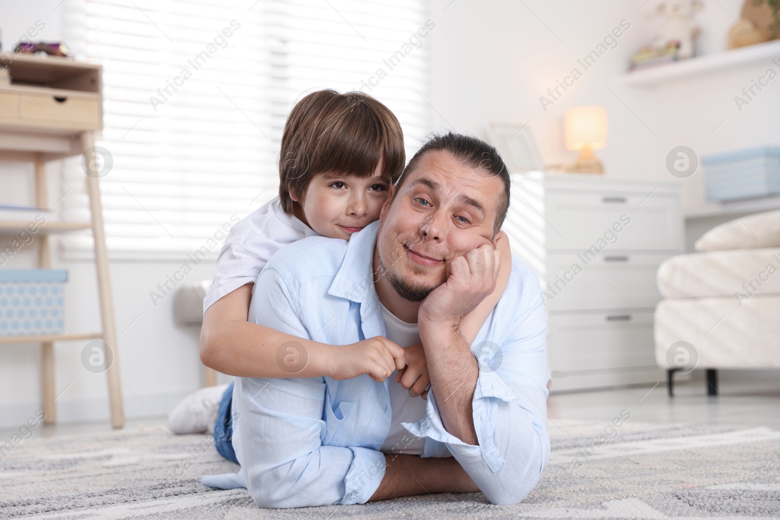 Father and his son on floor at home Photo of Father and his son on floor at home