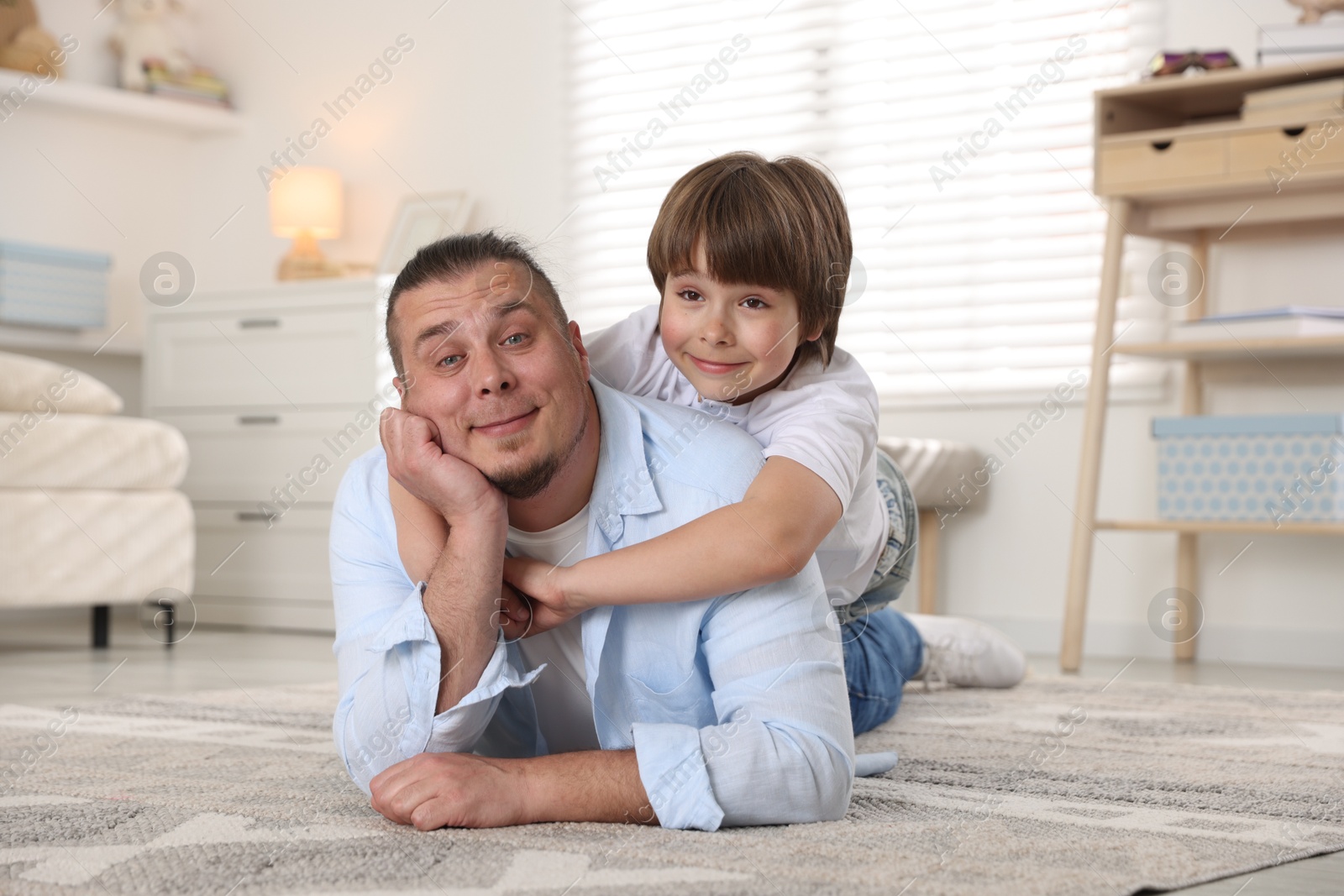 Father and his son on floor at home Photo of Father and his son on floor at home