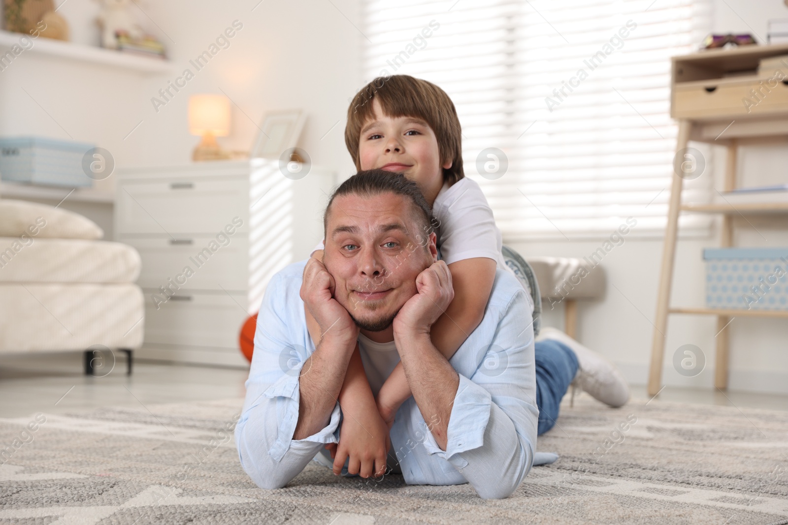 Father and his son on floor at home Photo of Father and his son on floor at home
