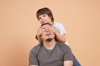 Photo of Father and his son on beige background