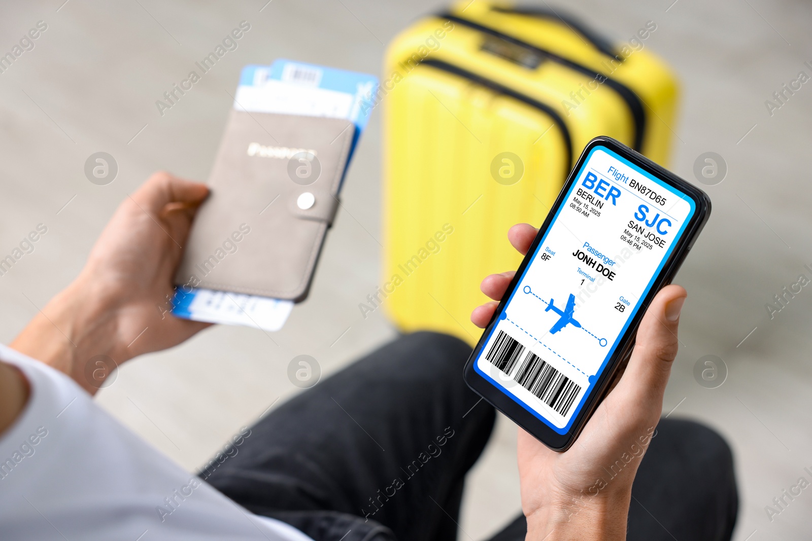 Tourist holding mobile phone with e-ticket for airplane and passport indoors, closeup Image of Tourist holding mobile phone with e-ticket for airplane and passport indoors, closeup