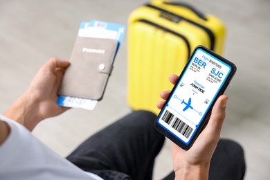 Image of Tourist holding mobile phone with e-ticket for airplane and passport indoors, closeup