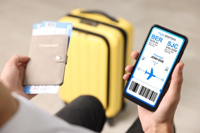 Image of Tourist holding mobile phone with e-ticket for airplane and passport indoors, closeup