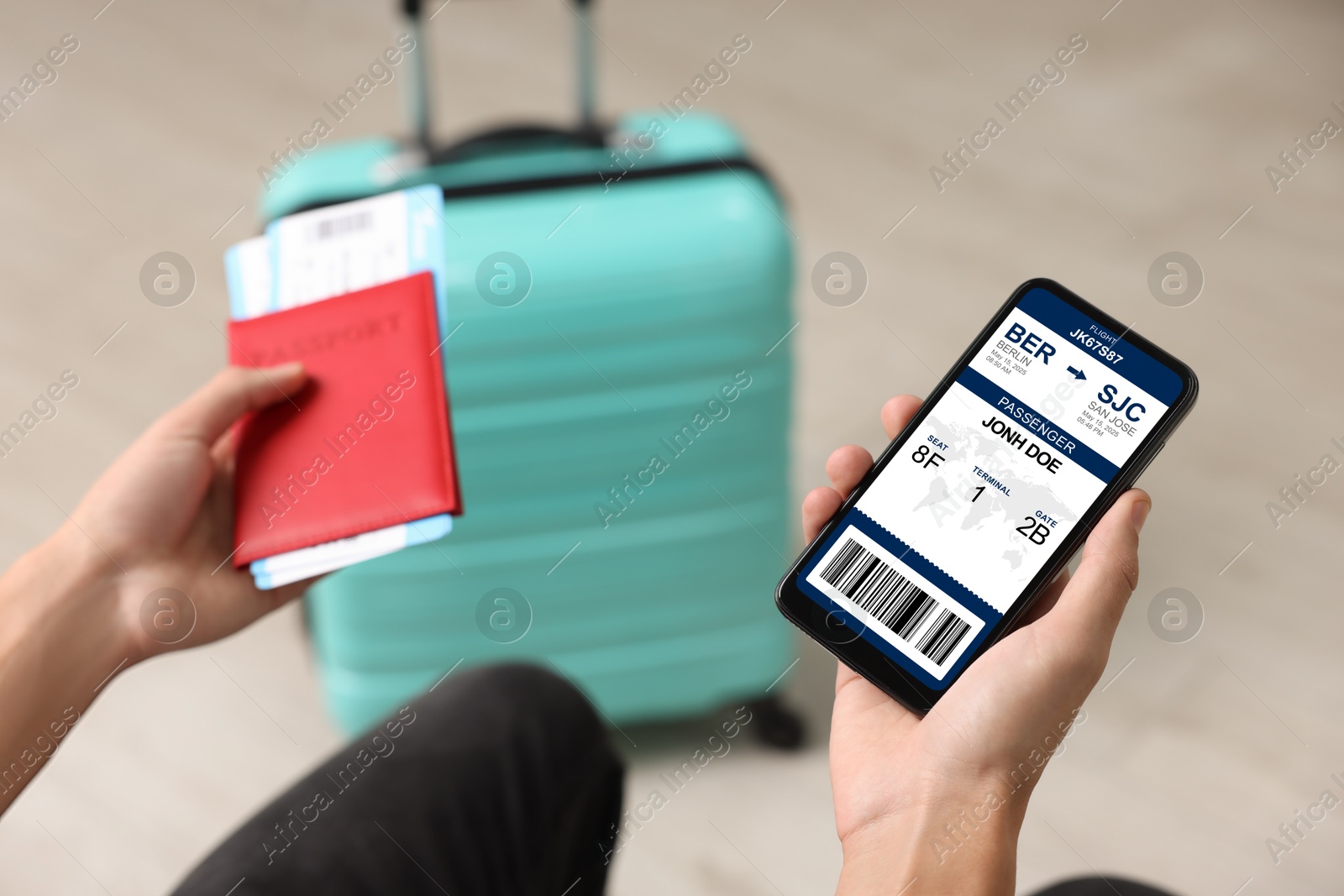 Tourist holding mobile phone with e-ticket for airplane and passport indoors, closeup Image of Tourist holding mobile phone with e-ticket for airplane and passport indoors, closeup
