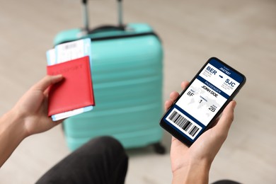 Image of Tourist holding mobile phone with e-ticket for airplane and passport indoors, closeup