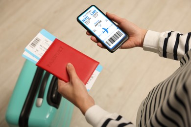 Image of Tourist holding mobile phone with e-ticket for airplane and passport indoors, closeup