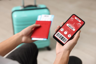 Image of Tourist holding mobile phone with e-ticket for airplane and passport indoors, closeup