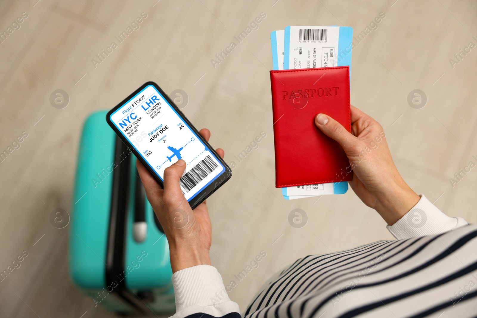 Tourist holding mobile phone with e-ticket for airplane and passport indoors, closeup Image of Tourist holding mobile phone with e-ticket for airplane and passport indoors, closeup