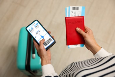 Image of Tourist holding mobile phone with e-ticket for airplane and passport indoors, closeup